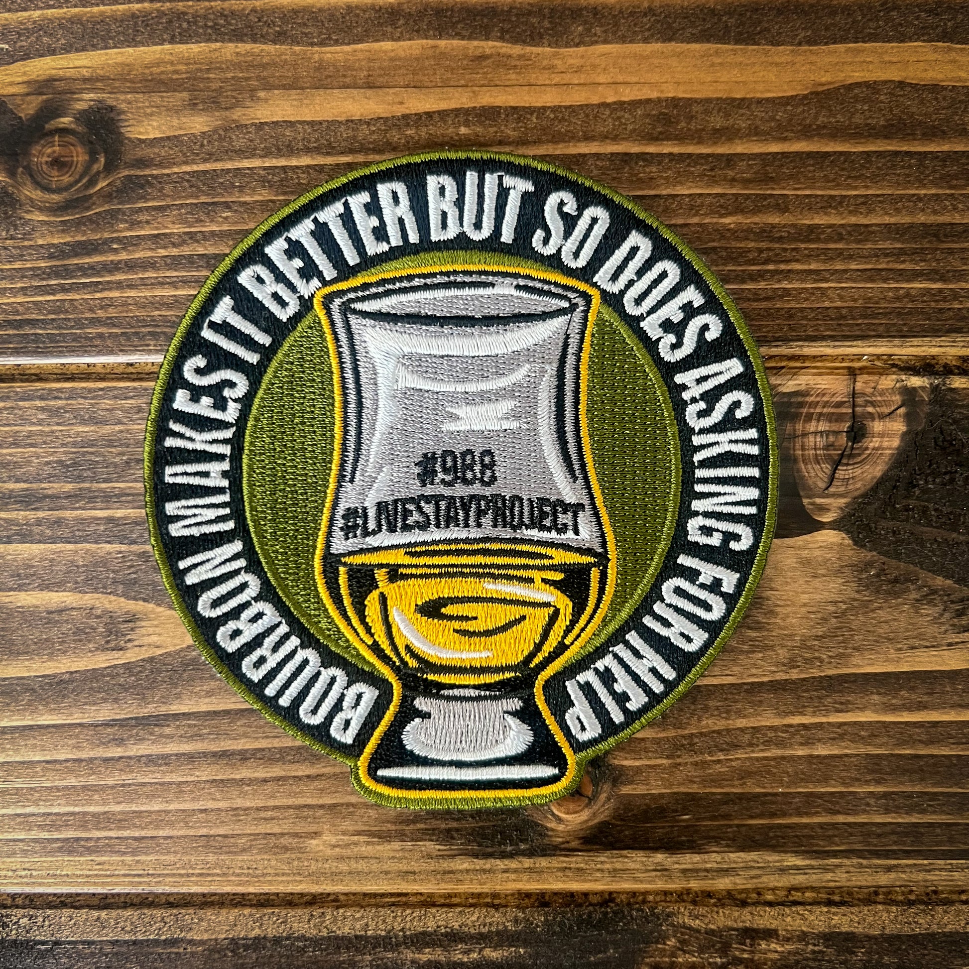 Shows embroidered sew-on patch that reads, "Bourbon makes it better but so does asking for help"